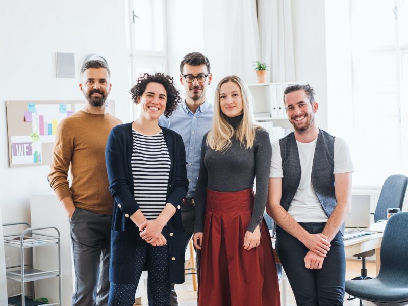 a-portrait-of-group-of-young-businesspeople-standing-in-a-modern-office-.jpg